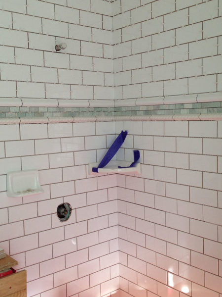 Subway tile in shower with accent strip